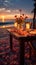 A romantic beach dinner candlelit ambiance, blooming flowers, sunset sky?›ƒ?ªƒ?love in the air